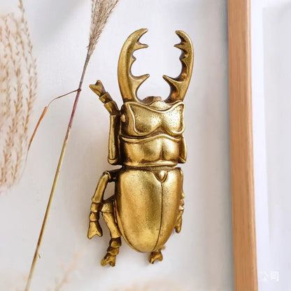 Intricate golden beetle resin wall decor featuring detailed sculpted features and a polished metallic finish