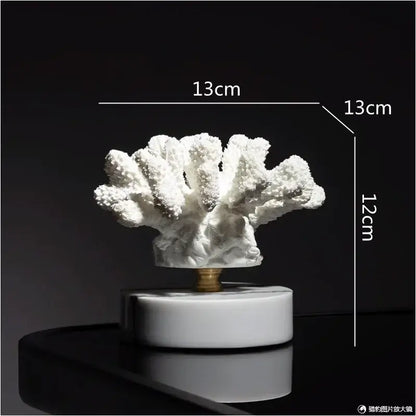 White coral resin ornaments with textured branching arms on a sleek white marble base for living room decor