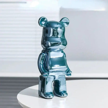 Shiny teal metallic bearbrick piggy bank with glossy reflective surface as iridescent cabinet sculpture decor