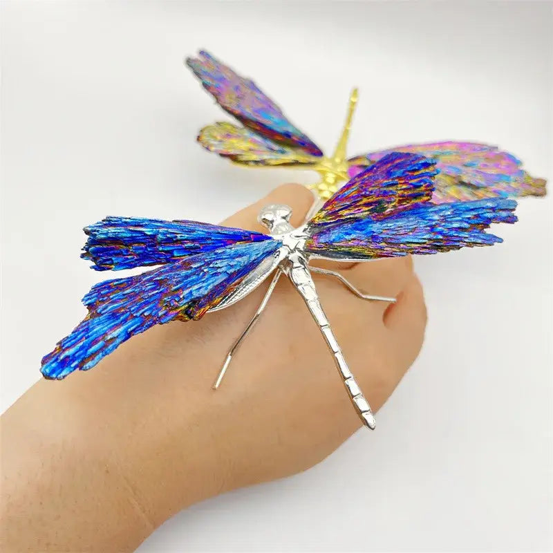 A vibrant iridescent blue and purple crystal dragonfly brooch made of metallic material for decorative figurines decorbites