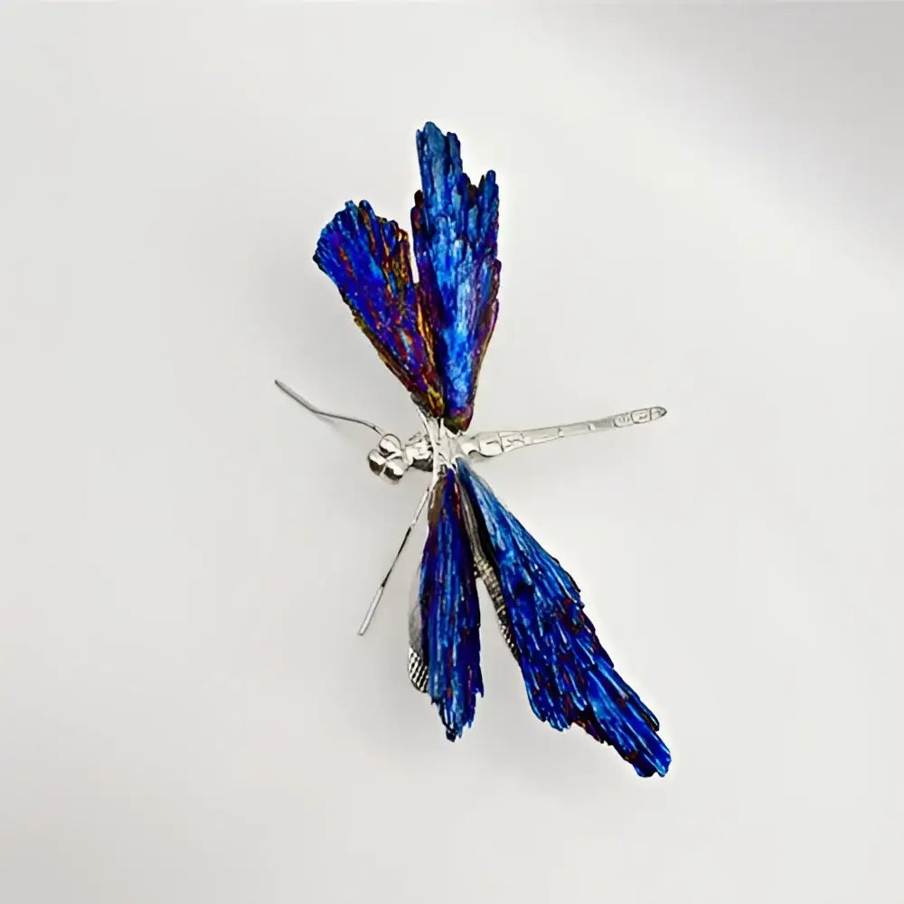 A delicate crystal dragonfly brooch with iridescent blue wings and silver body for decorative figurines decorbites collection