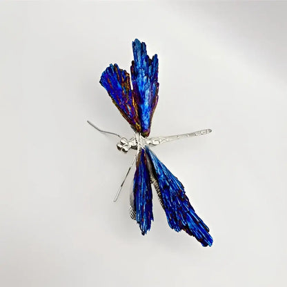 A delicate crystal dragonfly brooch with iridescent blue wings and silver body for decorative figurines decorbites collection