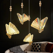Iridescent gold butterfly pendant lights with rainbow wings and metallic accents for living and dining rooms