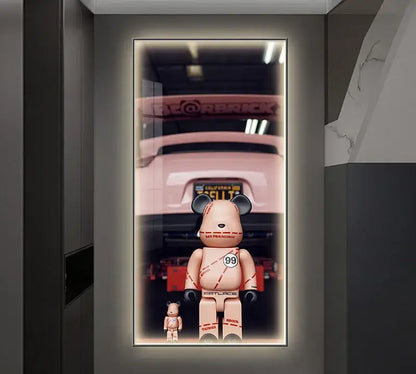 Pink bearbrick figures with red stitching beside an iron man metallic bearbrick led wall lamp for bedroom decor