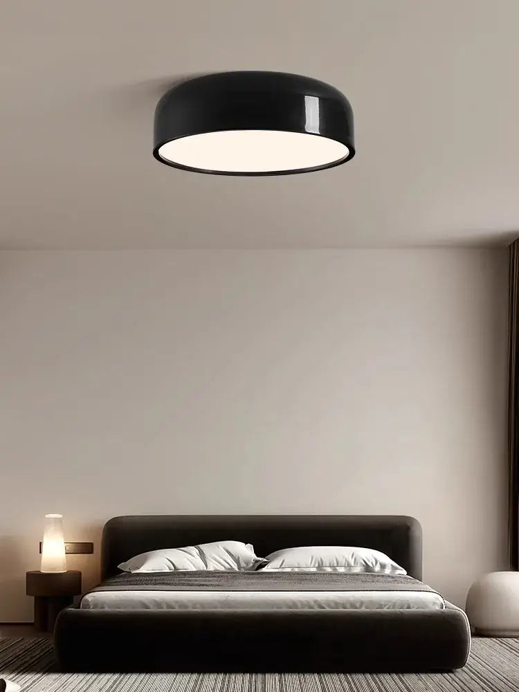 Black circular ceiling lamp with glossy finish and soft white illumination decorbites italian minimalist round design