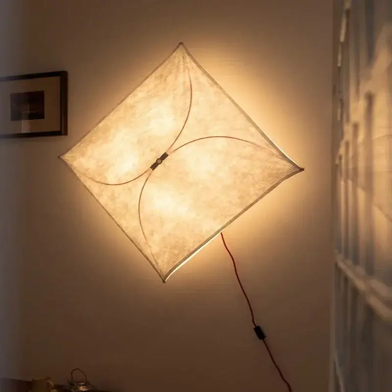 A warm italian vintage ceiling light with diamond-shaped beige fabric shade and thin black structural lines by decorbites italian vintage