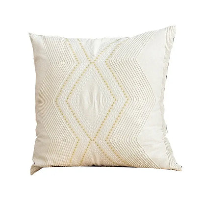 Cream-colored cushion cover with geometric embroidery of stitched diamond shapes for decorbites ivory geometric decor