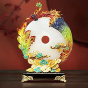 A vibrant multi-colored phoenix jade dragon phoenix ornament on a white jade-like yin-yang disc with gold accents