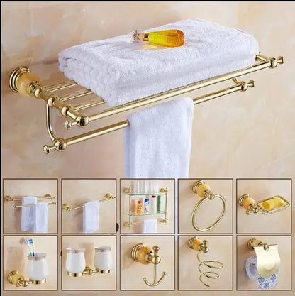 Gold-finished bathroom towel rack with polished surface and ornate spheres holding white towels in jade gold bathroom accessories set