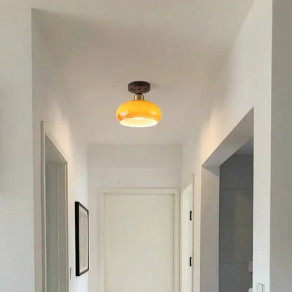 A warm yellow glass ceiling lamp with brass finish by decorbites led ceiling for living room decor