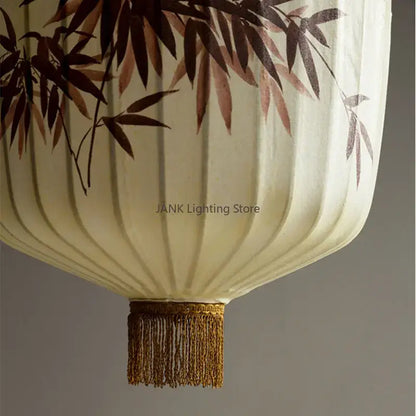Cream-colored Japanese paper lantern with delicate brown bamboo leaf pattern and golden tassel for living room pendant light