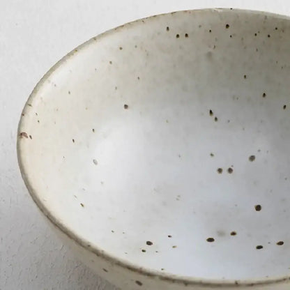 A white handmade ceramic rice bowl with speckled brown glaze for japanese beige and brown ceramic rice bowl set dining room