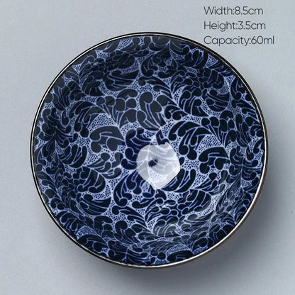A blue and white decorbites ceramic kung fu tea porcelain bowl with floral pattern glossy finish and metallic rim