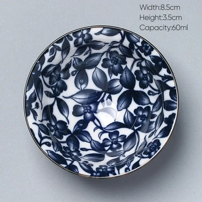A delicate white porcelain kung fu tea cup with navy blue floral patterns and metallic rim by decorbites ceramic