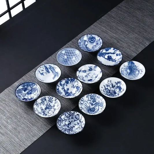 Set of ten blue and white ceramic kung fu tea cups with intricate floral fish bamboo and bird motifs for dining room use