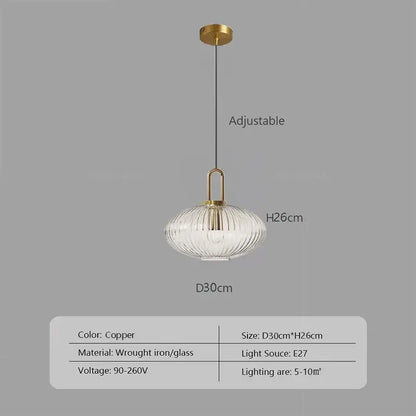 Copper-finished pendant light with ribbed glass stone shade and wrought iron hardware helps create warm kitchen ambiance