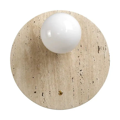 A sleek Japanese minimalist beige cave stone wall lamp with textured base and white spherical bulb for bedroom decor
