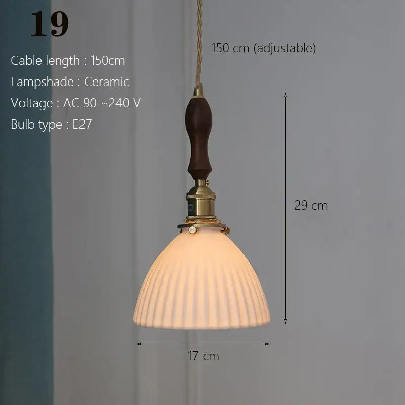 A warm-toned ceramic pendant light with fluted white shade and brass hardware for kitchen and dining room