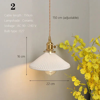 White ceramic pendant light with fluted ribbed design and brass hardware for kitchen and dining room use