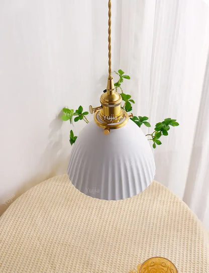 White ribbed ceramic pendant light with brass fixture and twisted cord for kitchen and dining room use