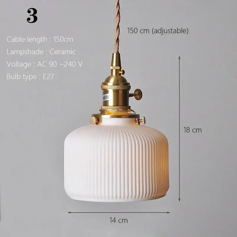 White ceramic pendant light with vertical ridges and brass fixture ideal for kitchen or dining room lighting