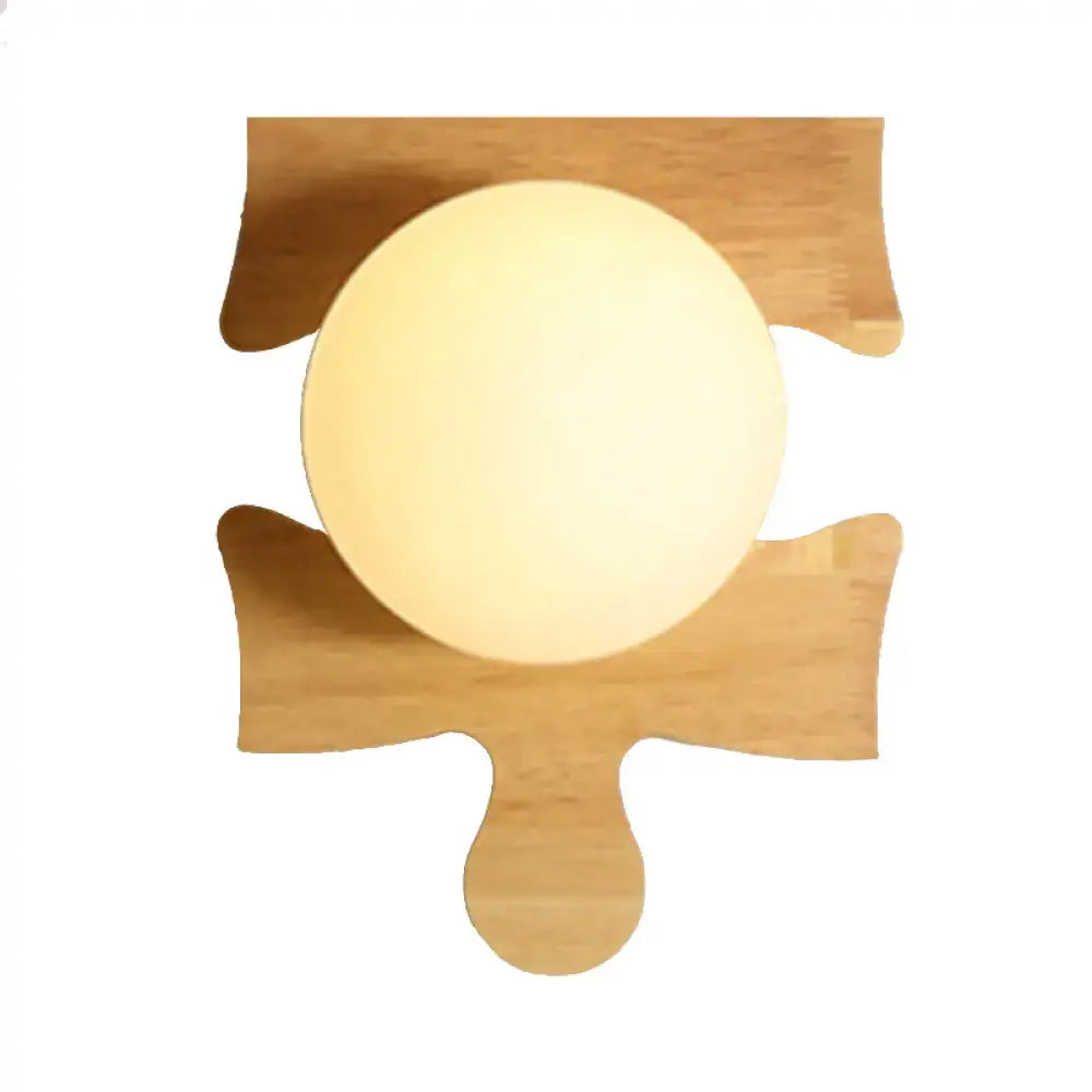 Warm softly glowing wall light with a beige wooden puzzle base mounted on a light bamboo wooden puzzle design