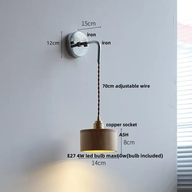 Minimalist Japanese style black and brass wall lamp with polished iron bracket, adjustable copper wire, wooden shade, and pull chain