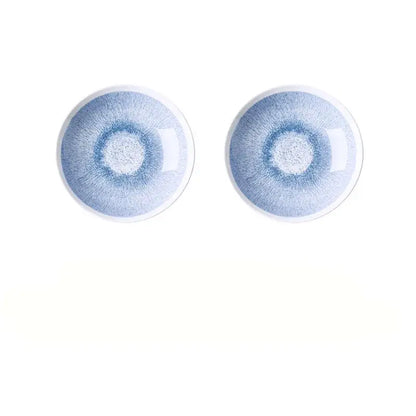 Two identical Japanese style blue and white ceramic deep dish bowls with a glossy light blue radial glaze pattern