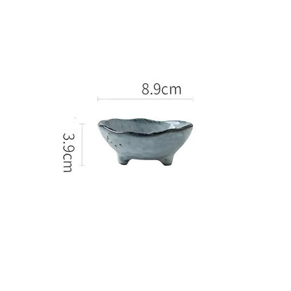 A small gray ceramic sauce dishes rice bowl with textured surface and three short feet for japanese style dining