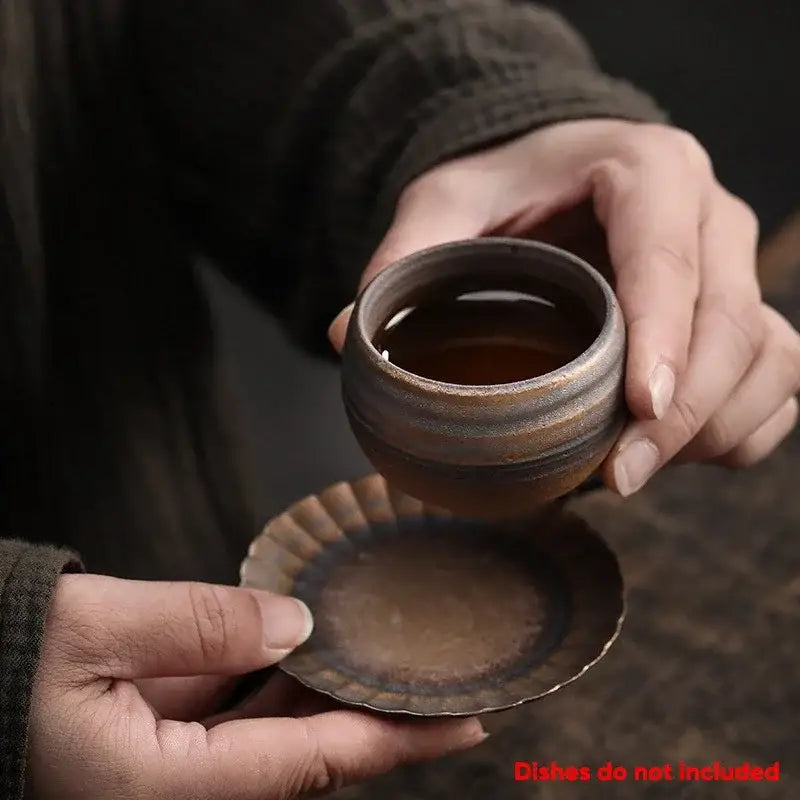 A japanese style porcelain coffee tea cup with earthy brown glaze and subtle horizontal ridges for dining room use