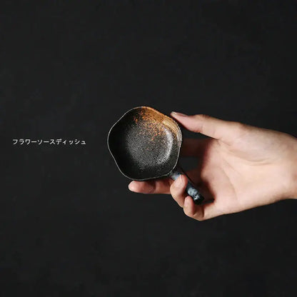 Handcrafted black ceramic flower sauce dish with rustic speckled glaze and brown patina rim in japanese style retro decorbites design