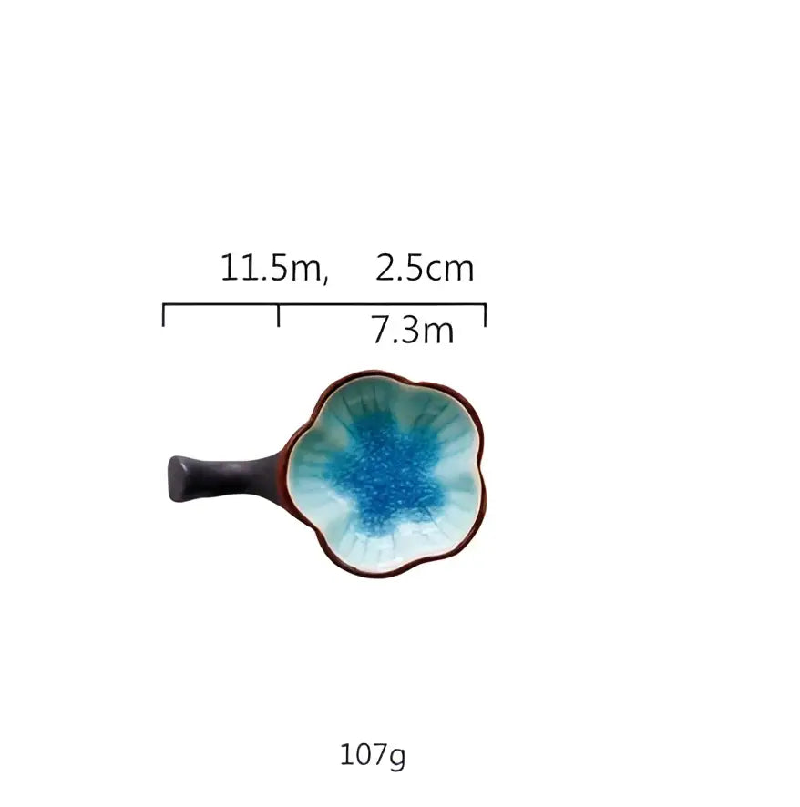 A japanese style retro ceramic sauce dish with a blue petal design and dark brown handle by decorbites