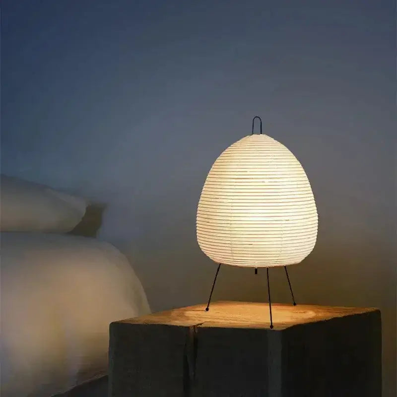 Warmly glowing japanese style rice paper table lamp with minimalist metal stand for bedroom decorbites japanese style