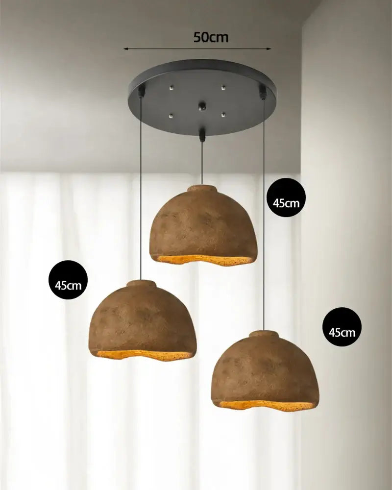 Set of three rustic brown resin pendant lights with matte finish and warm interior glow for dining room use