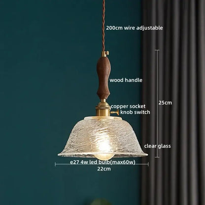 Japanese style pendant lamp featuring warm-toned decorbites clear glass shade with wood trim for dining room use