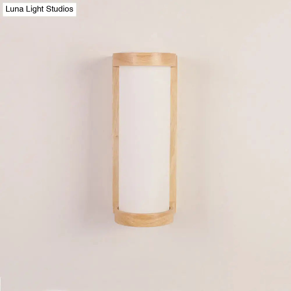 Minimalist Japanese style wall sconce lamp with a light wood frame and frosted white glass panel for bedroom use