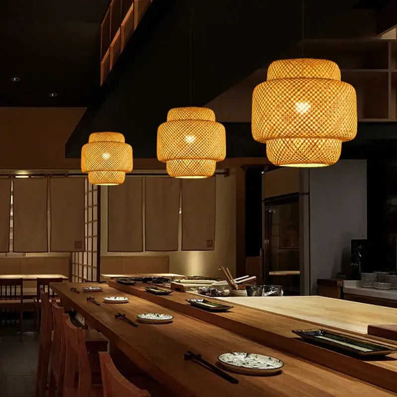 Warm-toned Japanese tiered pendant light with woven bamboo construction creates a natural materials focal point above dining table