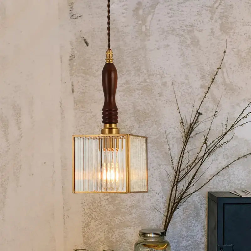 A warm-toned japanese vintage brass and wood glass led pendant lamp with vertical panels for dining room use