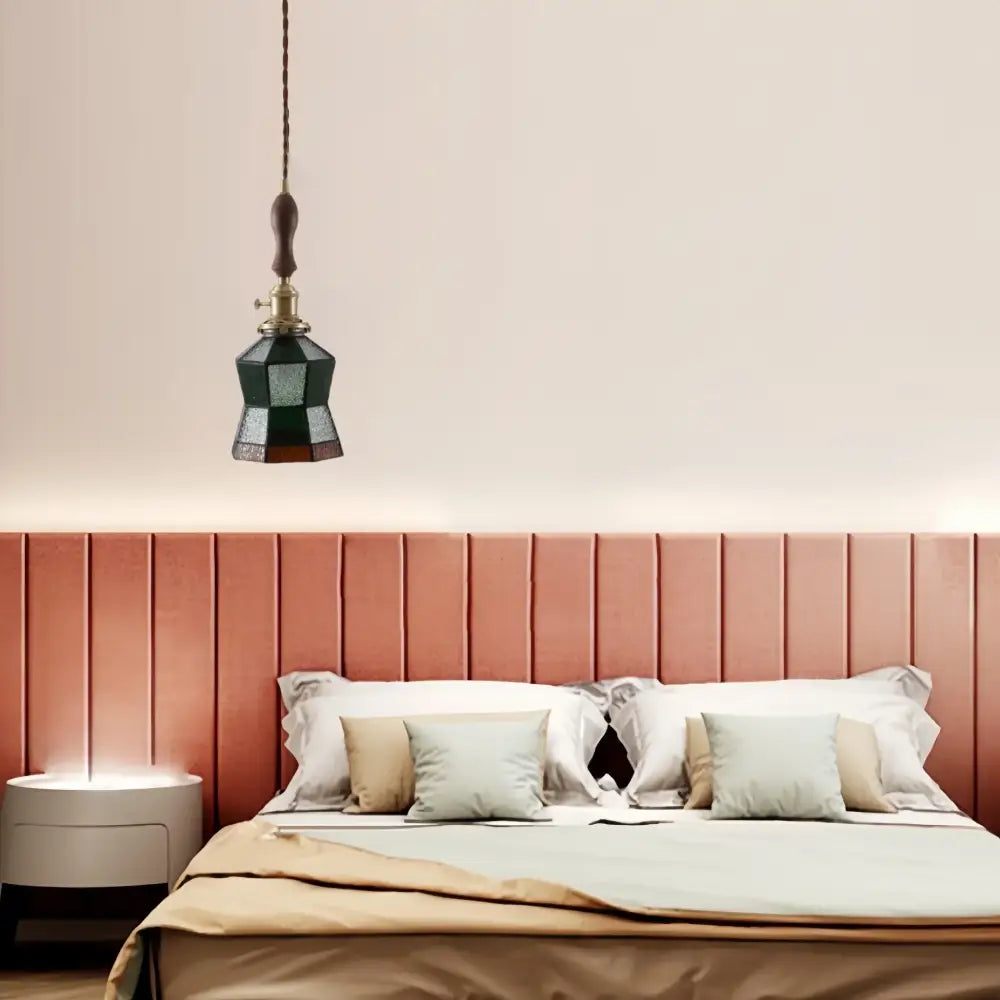 Japanese vintage dark green faceted glass led pendant lamp with brass fixture and wooden pull chain above bed