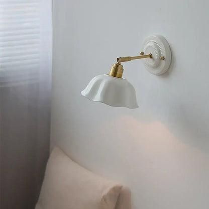 Japanese vintage white ceramic led wall sconce with gold-toned metal arm and decorative base for bedroom decorbites ceramic led wall