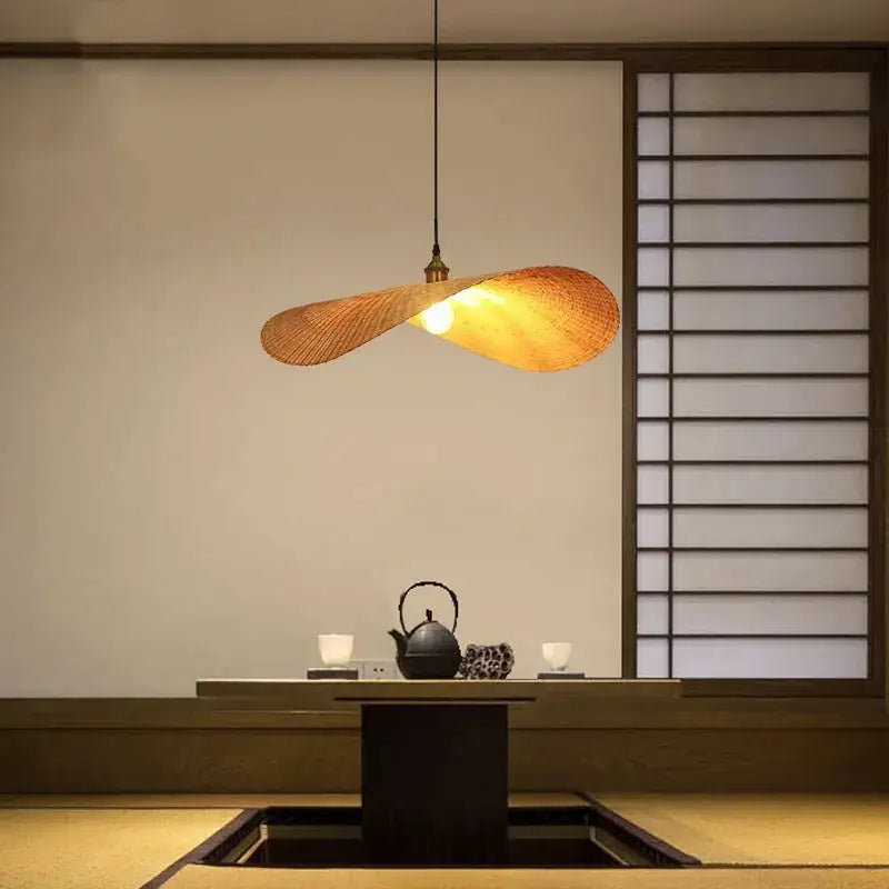 A warm golden woven bamboo chandelier with sleek twisted design hanging for living room by decorbites bamboo chandelier