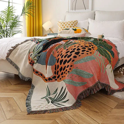 Vibrant jungle pink and cream leopard print throw blanket with bold orange leopard, green leaves, fringed edges decorbites leopard print