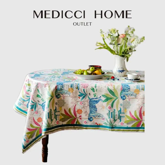 Jungle vibes tablecloth by decorbites featuring blue and green striped tigers and floral motifs on cream fabric for kitchen decor
