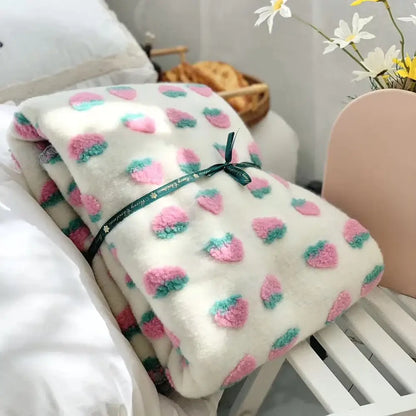 A plush white kids wool blanket with pink green strawberry appliqués tied with dark green ribbon for decorbites 3d cherry decor