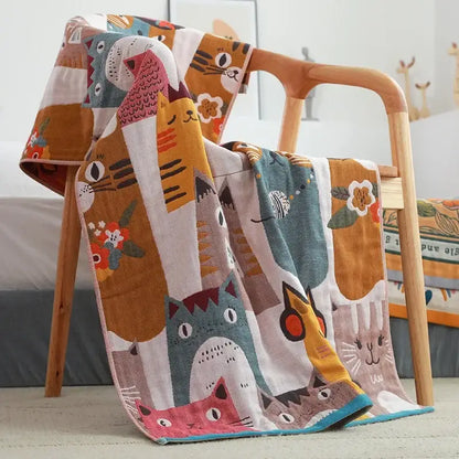 A multicolored cotton gauze bath towel with a playful kids cute cats pattern by decorbites for bathroom use