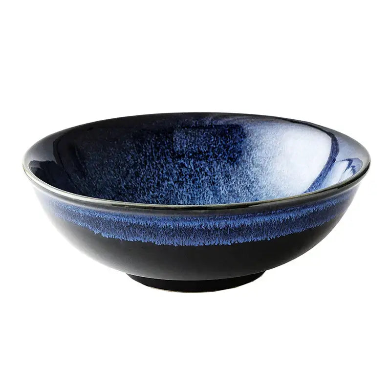 A kiln glazed ceramic bowl with a blue speckled gradient and glossy finish for dining room ramen use