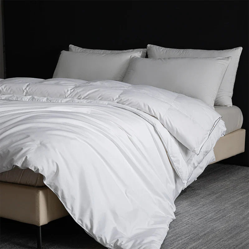 White quilted king size goose down and silk duvet set with smooth satin finish and subtle stitching details