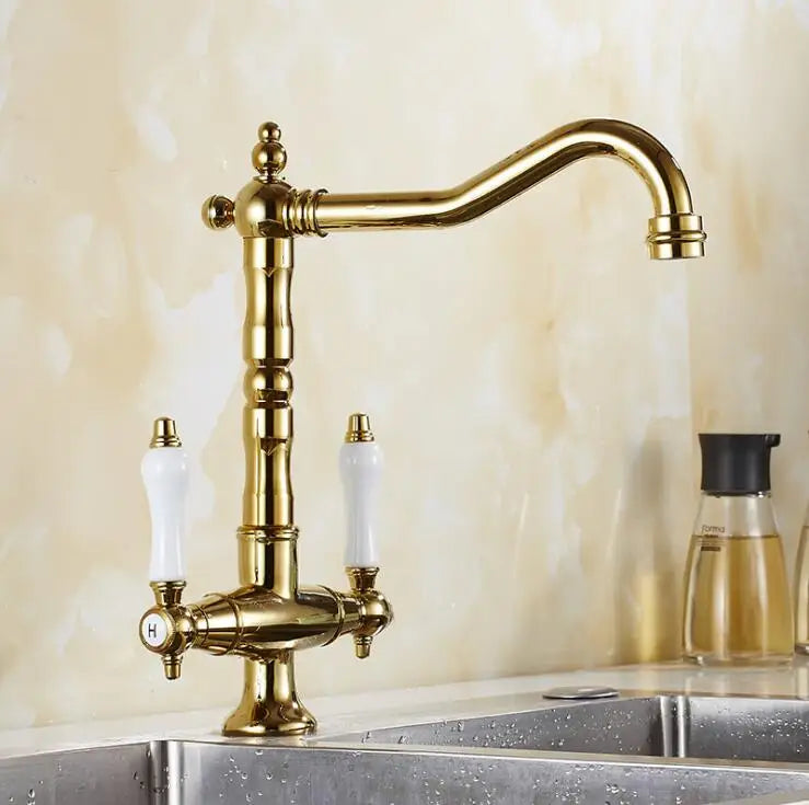 Antique brass single hole kitchen faucet with white ceramic handles and 360 degree swivel curved spout
