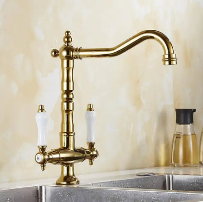 Antique brass single hole kitchen faucet with white ceramic handles and 360 degree swivel curved spout