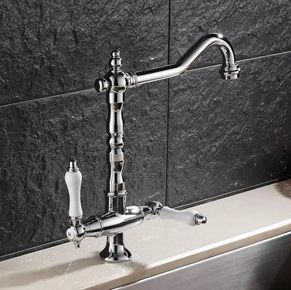 Chrome finished single hole kitchen faucet with elegant curved spout and two ivory ceramic handles for hot and cold water